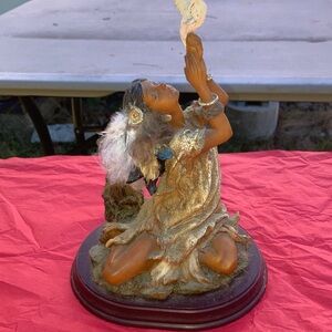 Native American Woman holding a bird Sculpture.